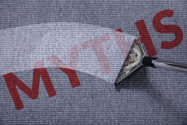 Red words MYTHS in carpet while being cleaned.