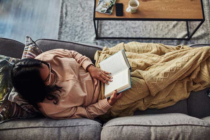 Woman laying on newly cleaned upholstered couch.