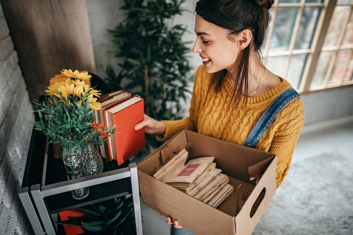 Young women unpacking in new rented apartment